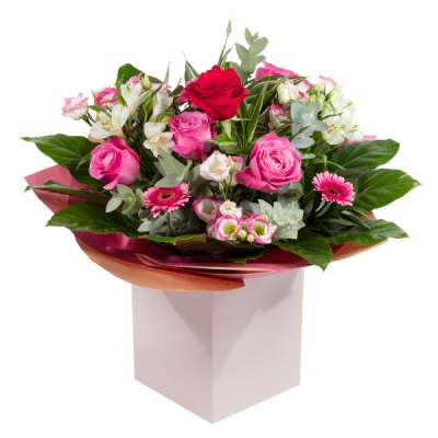 The Secret Admirer - Delight your special someone with "The Secret Admirer," a charming hand-tied bouquet perfect for making heartfelt moments unforgettable. Featuring a stunning mix of pink, red, white, and purple flowers, this arrangement offers timeless beauty with a seasonal twist, ensuring every bouquet is truly unique. Carefully wrapped and placed in a cardboard live vase, it combines elegance with practicality for effortless gifting.

The bouquet arrives without water to protect the packaging, but its inner container can be topped up to keep the flowers fresh. For an even more personal touch, it can easily be removed and placed in your own vase at home. Whether for a romantic gesture, a thoughtful surprise, or simply to brighten someone's day, "The Secret Admirer" speaks volumes. Experience the joy of giving with this vibrant arrangement that blends convenience and sophistication in perfect harmony.