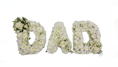 3 Letter - MUM or DAD Floral Setting - This elegant "Dad" floral tribute is a heartfelt way to honor and cherish the memory of a beloved father. Each letter is expertly crafted with pure white chrysanthemums, symbolizing purity, peace, and eternal love. Beautifully accented with sprays of white roses and lush greenery, the arrangement exudes grace and reverence. The delicate details, including baby's breath and foliage, add depth and a natural touch to the design.

Perfect for funerals or memorial services, this tribute conveys love, respect, and deep admiration for a father’s life and legacy. Its thoughtful and dignified composition ensures it stands out as a meaningful centerpiece or graveside arrangement. Handcrafted with care, this floral tribute provides comfort and support to grieving families while celebrating the enduring bond shared with a father. This timeless arrangement is a lasting symbol of remembrance and love during a difficult time.